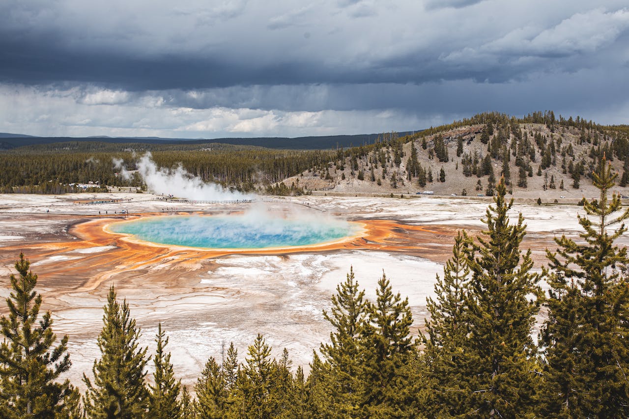 Image of Old Faithful erupting. The geyser is spewing hot water and steam into the air.